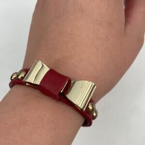 Gold tone bow red leather bracelet